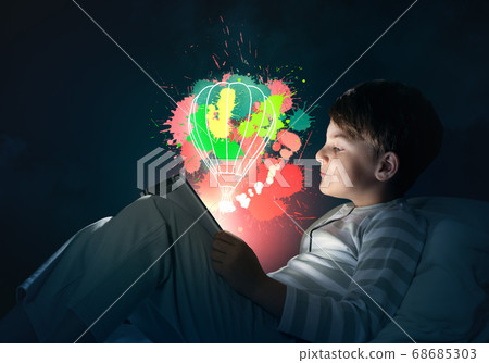 Boy with tablet in his bed 68685303