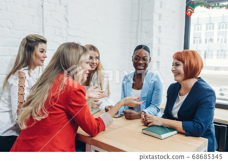 Young women team up with freelance friends and create a small coworking club. Young women team up with freelance friends and create a small coworking club. 68685345