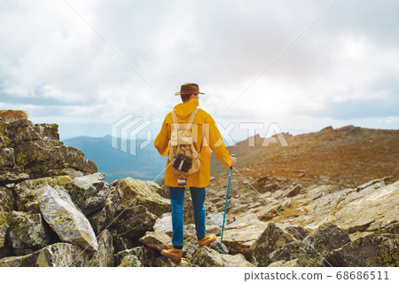 motivated hiker at the top of a rock with backpack enjoy autumn day 68686511
