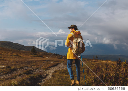young man in fashion clothes walking on a cloudy day 68686566