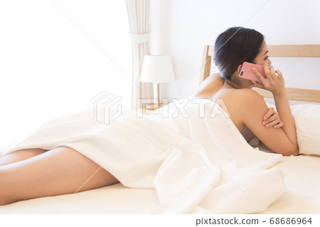 Women calling in bed Women calling in bed 68686964