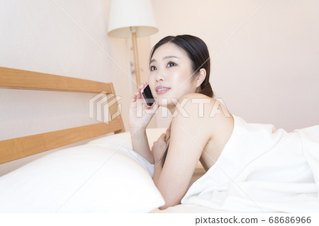 Women calling in bed Women calling in bed 68686966