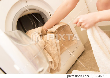 Woman doing the laundry Woman doing the laundry 68686996