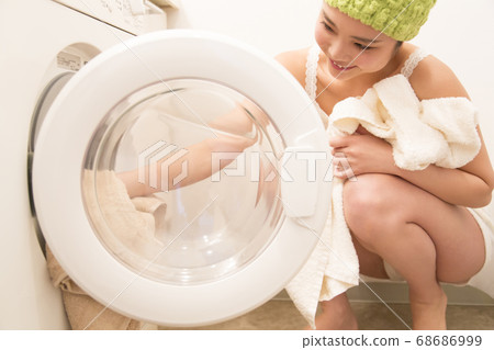 Woman doing the laundry Woman doing the laundry 68686999