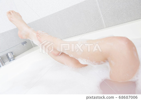 A woman taking a bath 68687006