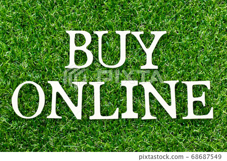 Wood alphabet letter in word buy online on green grass background Wood alphabet letter in word buy online on green grass background 68687549