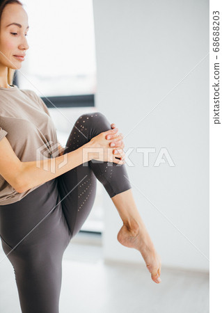 beautiful woman stretching legs before jogging beautiful woman stretching legs before jogging 68688203