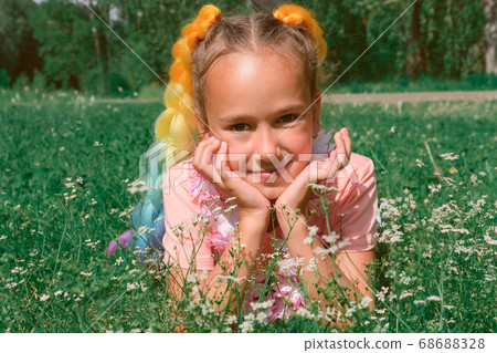 beautiful girl's portrait. girl laying on a grass beautiful girl's portrait. girl laying on a grass 68688328