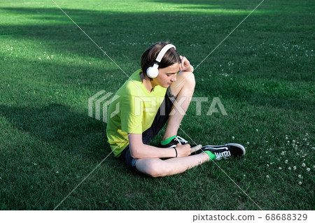 handsome teenager boy listening to the music handsome teenager boy listening to the music 68688329