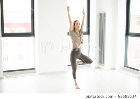sporty young woman with streatched arms doing morning exercise sporty young woman with streatched arms doing morning exercise 68688534