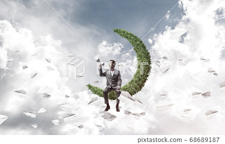 Businessman announcing something in loudspeaker and paper planes fly around 68689187
