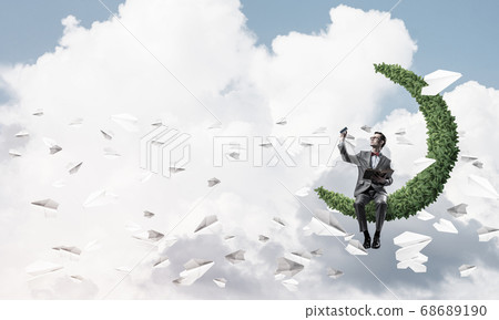 Young businessman or student studying the science and paper planes fly around Young businessman or student studying the science and paper planes fly around 68689190