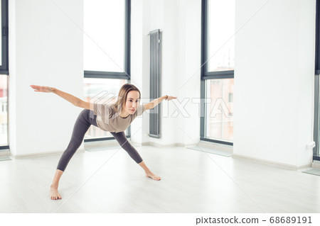 Young fashionable sportswoman wearing trendy sport outfit bending forward Young fashionable sportswoman wearing trendy sport outfit bending forward 68689191
