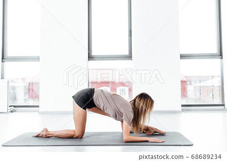woman practicing yoga on the mat woman practicing yoga on the mat 68689234