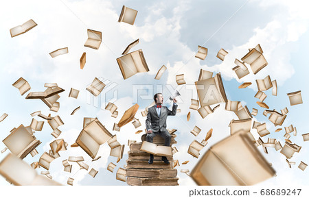 Businessman floating in sky and announcing something in loudspeaker Businessman floating in sky and announcing something in loudspeaker 68689247