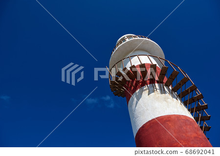 Boat on the beach and the lighthouse Boat on the beach and the lighthouse 68692041