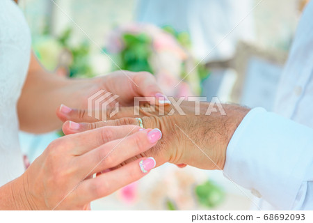 Hands of the newlyweds at the wedding ceremony of Hands of the newlyweds at the wedding ceremony of 68692093