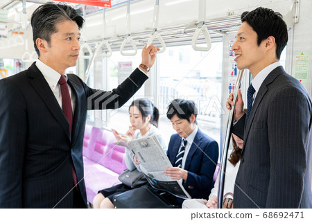 Businessmen talking on the train "Keio Electric Railway Co., Ltd." Businessmen talking on the train "Keio Electric Railway Co., Ltd." 68692471