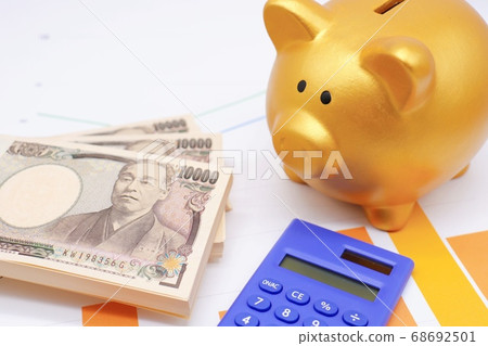 Piggy bank and wad of money Piggy bank and wad of money 68692501