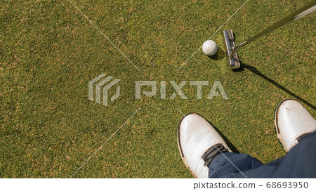 A person playing golf. A person playing golf. 68693950