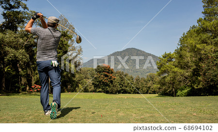 A person playing golf. A person playing golf. 68694102