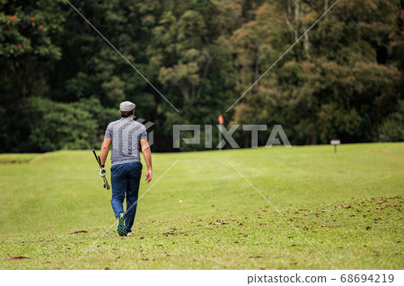 professional golfer on green grass professional golfer on green grass 68694219