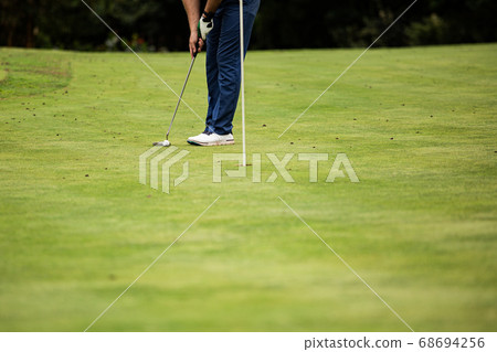 professional golfer on green grass professional golfer on green grass 68694256