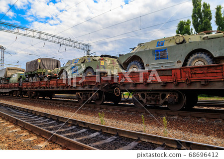 Cargo train carrying military vehicles Cargo train carrying military vehicles 68696412