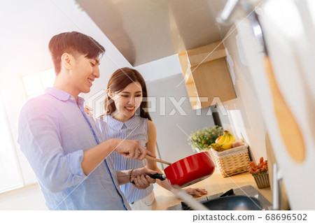asian couple cook happily 68696502