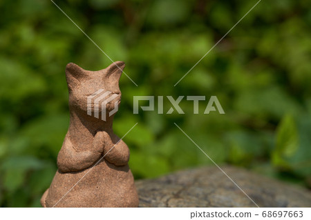 It is a pottery cat. It is a pottery cat. 68697663