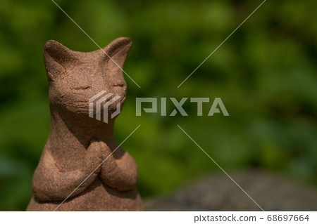 It is a pottery cat. It is a pottery cat. 68697664