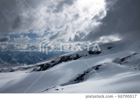Evening high mountain scenery snow-covered rocky steep mountains of the main mountain range of the northern Caucasus 68700017