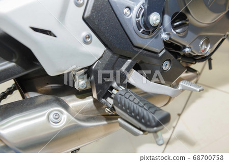 The master performs maintenance on the motorcycle. The master performs maintenance on the motorcycle. 68700758