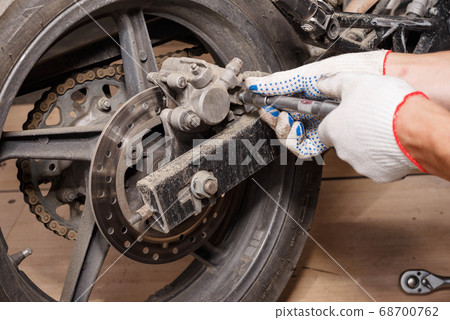 The process of replacing brake pads on a The process of replacing brake pads on a 68700762