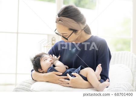 A mother holding a 5 month old baby 68701400