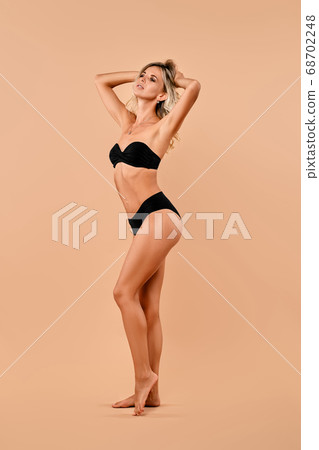 Full length portrait of woman in swimsuit 68702248