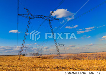 High voltage power line against blue sky 68702316