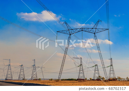 High voltage power line against blue sky 68702317