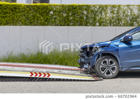 accident Car Slide on truck for move. Blue car accident Car Slide on truck for move. Blue car 68702964