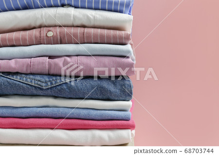 Clean garment neatly folded after laundry over Clean garment neatly folded after laundry over 68703744