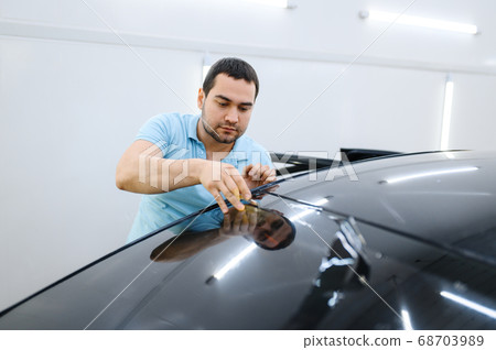 Male wrapper cuts car tinting, tuning service 68703989