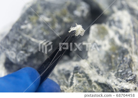 Chrysotile asbestos fiber close up. Chrysotile asbestos fiber close up. 68704458