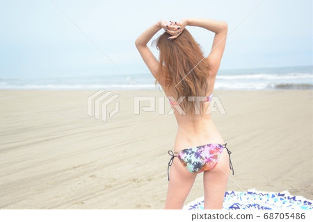 Swimsuit woman posing on the beach Swimsuit woman posing on the beach 68705486