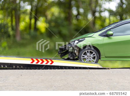 accident Car Slide on truck for move. Green car accident Car Slide on truck for move. Green car 68705542