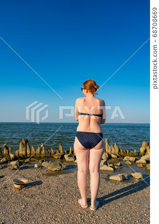 rear view. woman with excess weight in swimsuit 68708669