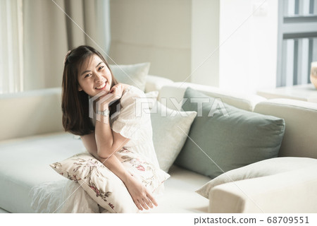 portrait of beautiful girl sitting on the sofa in portrait of beautiful girl sitting on the sofa in 68709551