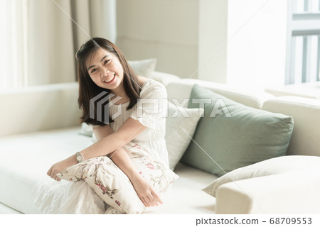 portrait of beautiful girl sitting on the sofa in portrait of beautiful girl sitting on the sofa in 68709553