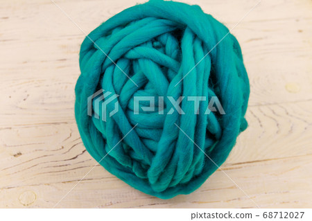 Merino wool yarn ball on white wooden background 68712027