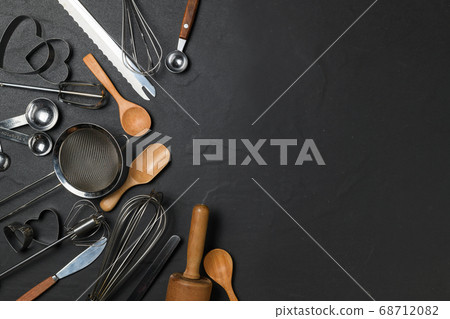 Kitchen utensils for pastries on black table and 68712082