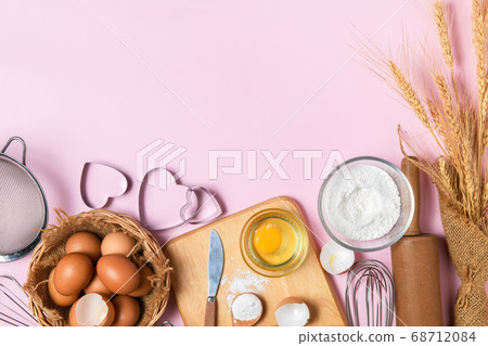 fresh eggs and cake flour  with kitchen utensils 68712084